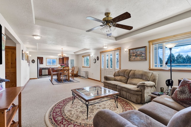 358 Hamilton Heights Rd, Corvallis, MT 59828 - living room featuring a textured ceiling, light colored carpet, baseboards, and a raised ceiling