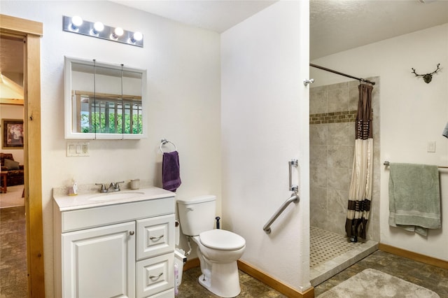 bathroom featuring toilet, vanity, and walk in shower