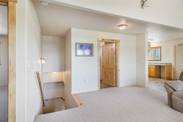 unfurnished bedroom featuring connected bathroom and light colored carpet