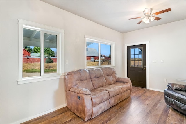 living room with a wealth of natural light, ceiling fan, and hardwood / wood-style flooring