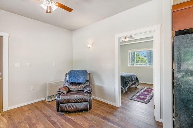 sitting room featuring ceiling fan and wood-type flooring