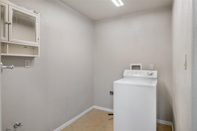 laundry room featuring cabinets and washer / dryer