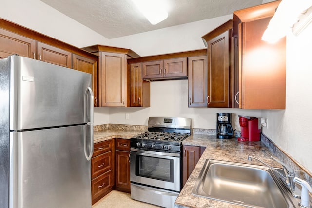 358 Hamilton Heights Rd, Corvallis, MT 59828 - kitchen featuring light countertops, a sink, brown cabinetry, and stainless steel appliances
