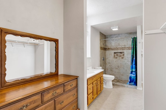 358 Hamilton Heights Rd, Corvallis, MT 59828 - bathroom with vanity, tile patterned flooring, toilet, and tiled shower
