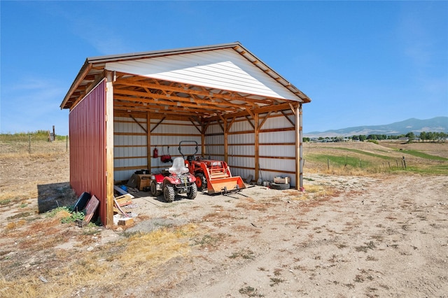 view of outdoor structure featuring a mountain view and a rural view