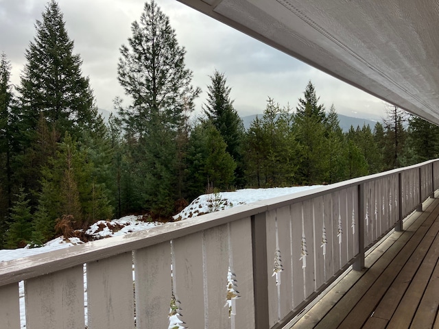 view of snow covered back of property