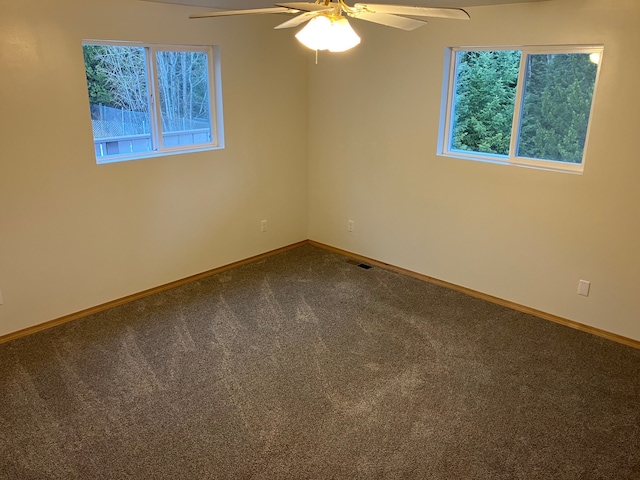 carpeted spare room with ceiling fan