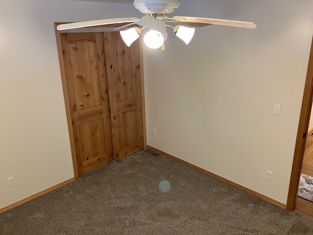 unfurnished bedroom featuring ceiling fan and carpet