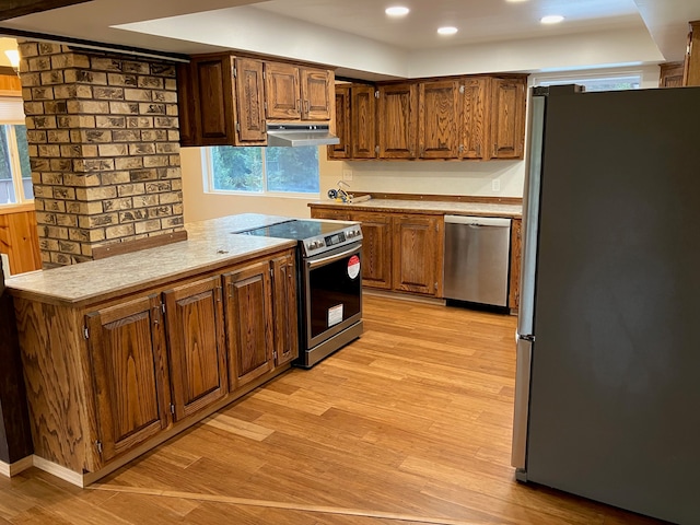 kitchen featuring stainless steel appliances and light wood-type flooring