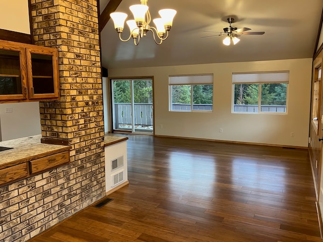 living room with lofted ceiling, dark wood-type flooring, and ceiling fan with notable chandelier