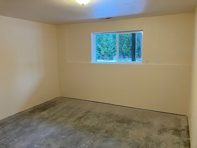 unfurnished room with concrete floors