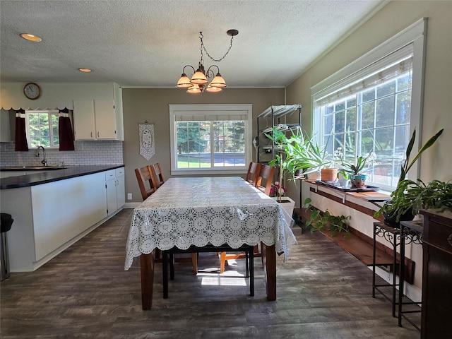 98 Railroad Ave, Heron, MT 59844 - dining room with healthy amount of natural light, a textured ceiling, a chandelier, dark wood finished floors, and recessed lighting