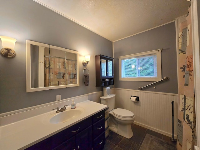 bathroom with tile patterned floors, vanity, toilet, and wood walls