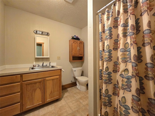 bathroom with walk in shower, tile patterned flooring, a textured ceiling, toilet, and vanity