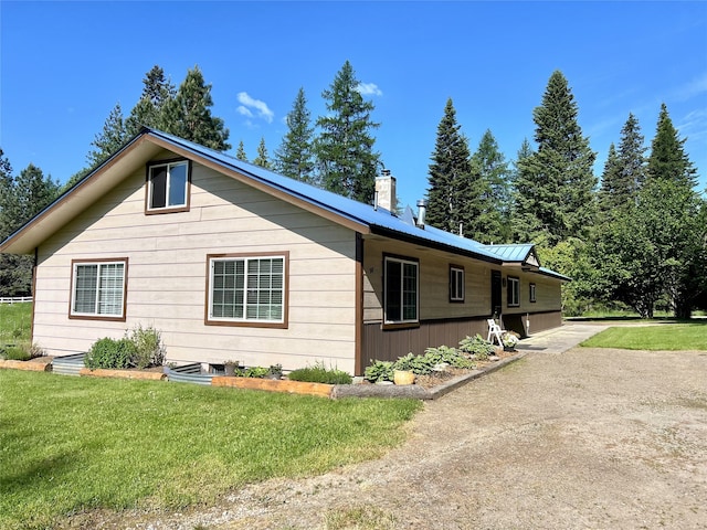 98 Railroad Ave, Heron, MT 59844 - view of side of home with a yard, a chimney, and metal roof