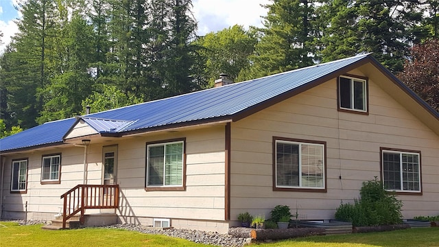 98 Railroad Ave, Heron, MT 59844 - view of property exterior featuring metal roof, a lawn, and a chimney