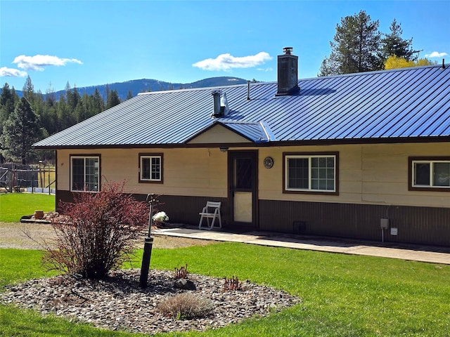 98 Railroad Ave, Heron, MT 59844 - ranch-style house with a chimney, a front yard, and metal roof