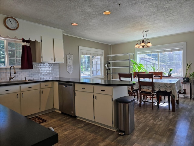 98 Railroad Ave, Heron, MT 59844 - kitchen featuring stainless steel dishwasher, a sink, dark wood finished floors, a peninsula, and dark countertops