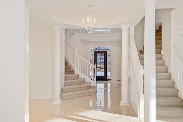 entrance foyer with a chandelier and decorative columns