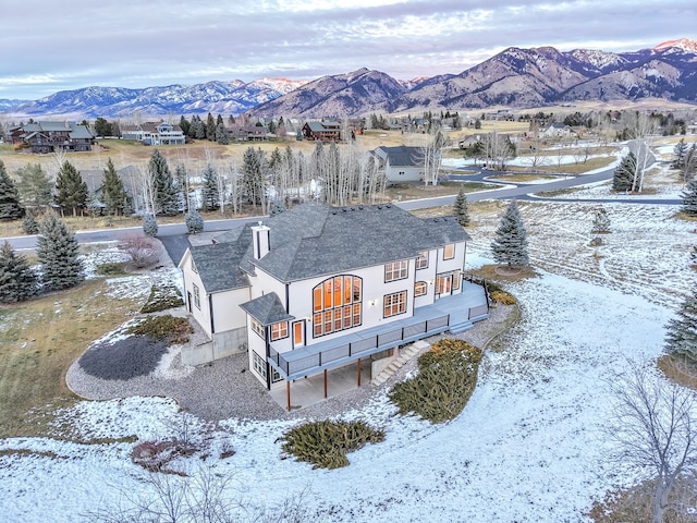 snowy aerial view with a mountain view