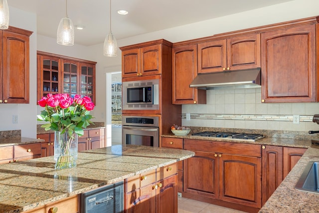 kitchen with pendant lighting, light stone countertops, light tile patterned floors, appliances with stainless steel finishes, and tasteful backsplash