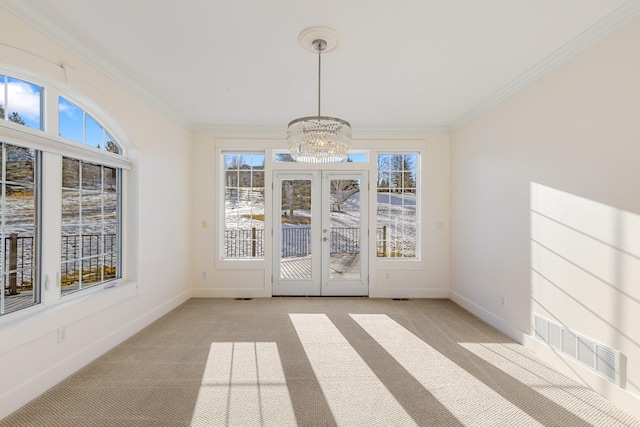 unfurnished sunroom featuring french doors and an inviting chandelier