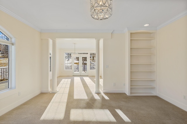 hall with french doors, light colored carpet, ornamental molding, and an inviting chandelier