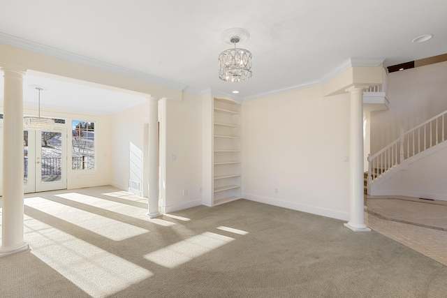 unfurnished living room with light carpet, built in shelves, crown molding, and a notable chandelier