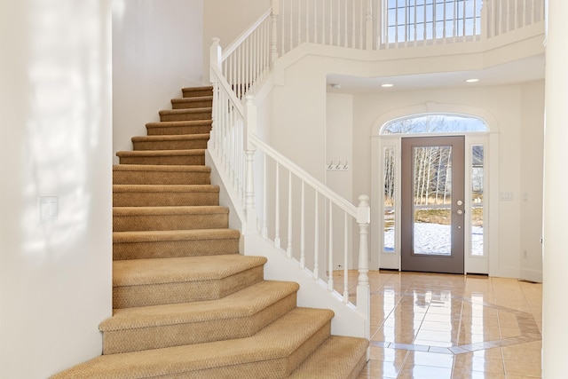 foyer entrance with a towering ceiling and a wealth of natural light