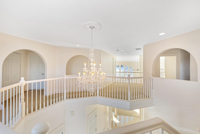 hallway featuring an inviting chandelier