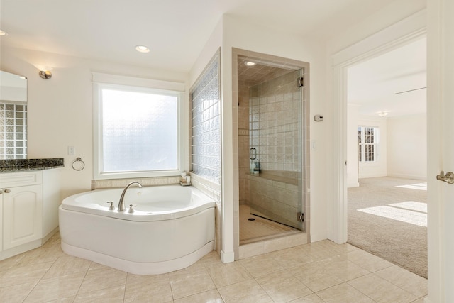 bathroom with tile patterned flooring, vanity, and a shower with door