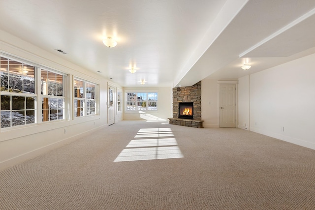 unfurnished living room with a fireplace and carpet flooring