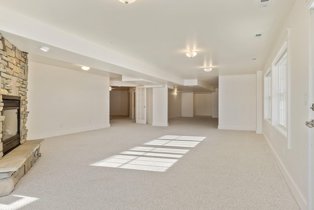 carpeted living room featuring a fireplace