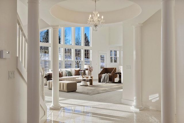 carpeted living room featuring a tray ceiling and a notable chandelier