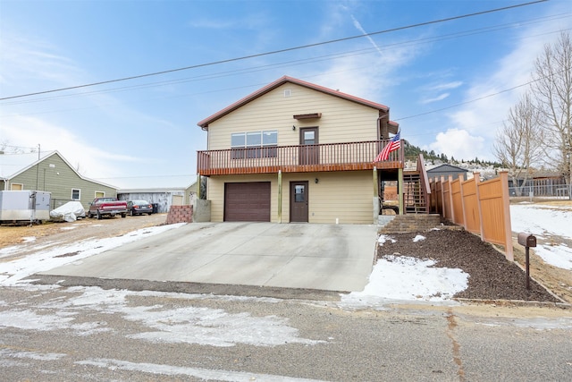 view of front of house featuring a garage and a wooden deck