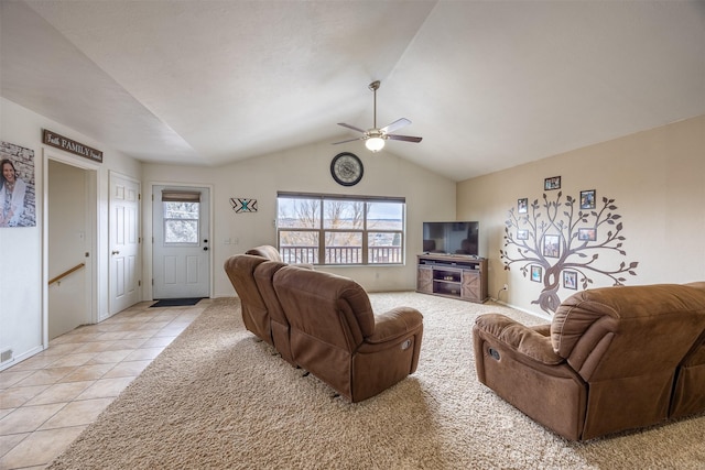 tiled living room with ceiling fan and lofted ceiling