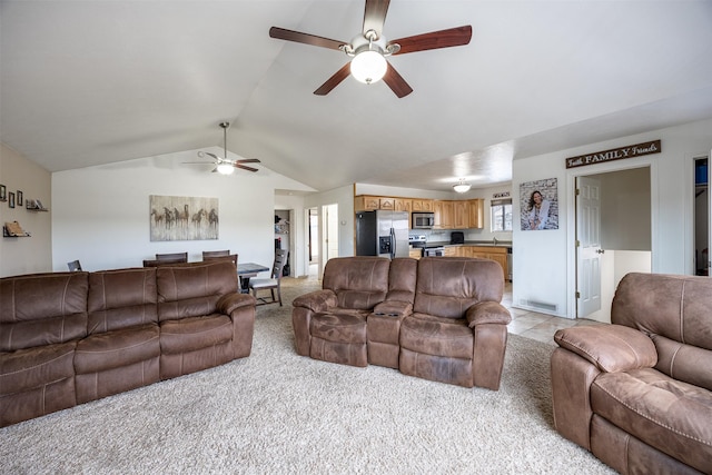 carpeted living room with ceiling fan and lofted ceiling