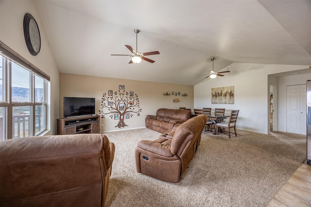 living room with ceiling fan and vaulted ceiling