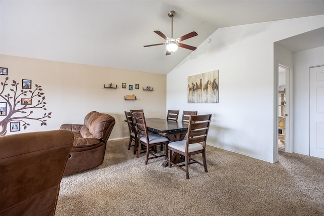 carpeted dining room featuring ceiling fan and vaulted ceiling