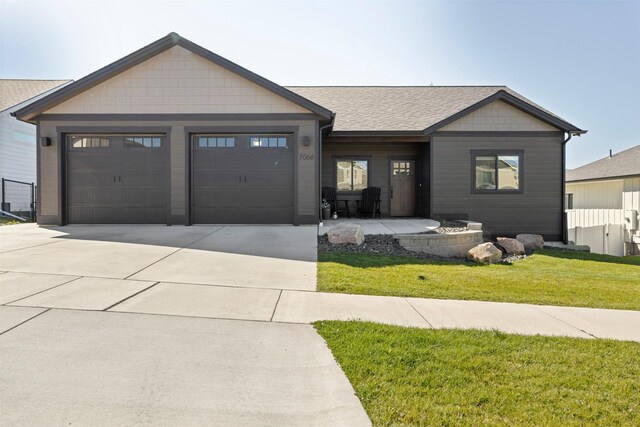 view of front of home featuring a front yard and a garage