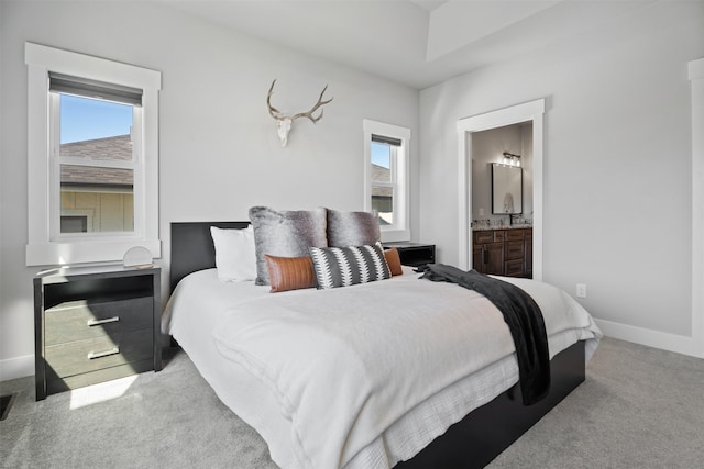 carpeted bedroom featuring ensuite bathroom