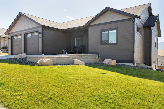 ranch-style home featuring a front lawn and a garage