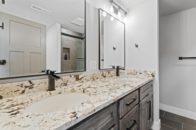 bathroom with tile patterned floors and vanity