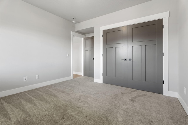 unfurnished bedroom featuring carpet floors and a closet