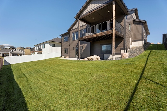 back of house with a lawn, a balcony, and a patio area