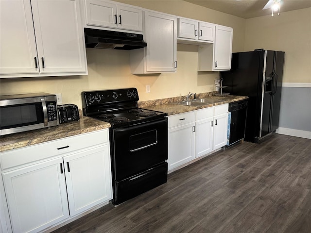 kitchen with dark stone counters, black appliances, white cabinets, sink, and dark hardwood / wood-style flooring