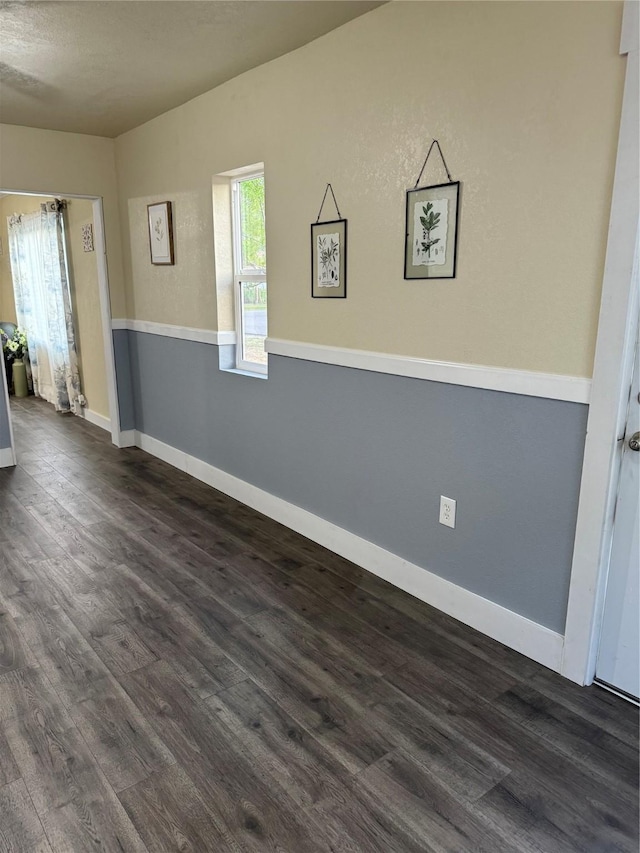 spare room with dark wood-type flooring