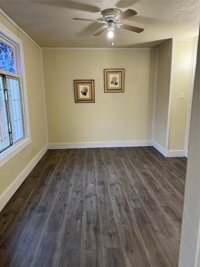 unfurnished room featuring ceiling fan, crown molding, dark wood-type flooring, and a textured ceiling