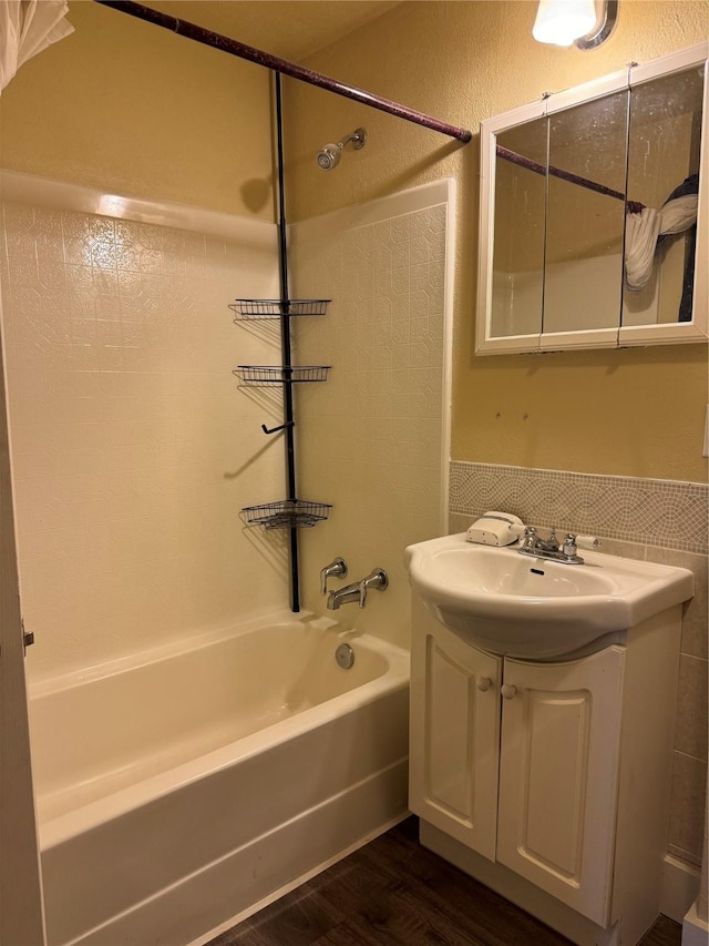 bathroom featuring bathtub / shower combination, wood-type flooring, and vanity