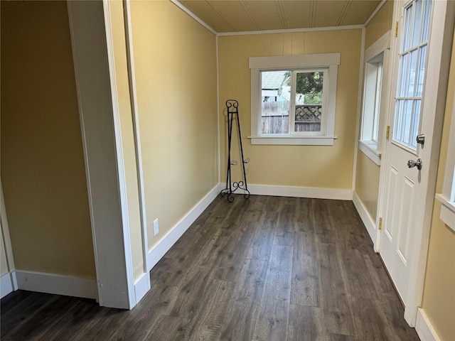 spare room with dark wood-type flooring and ornamental molding